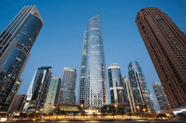 Modern cityscape with tall skyscrapers at twilight.