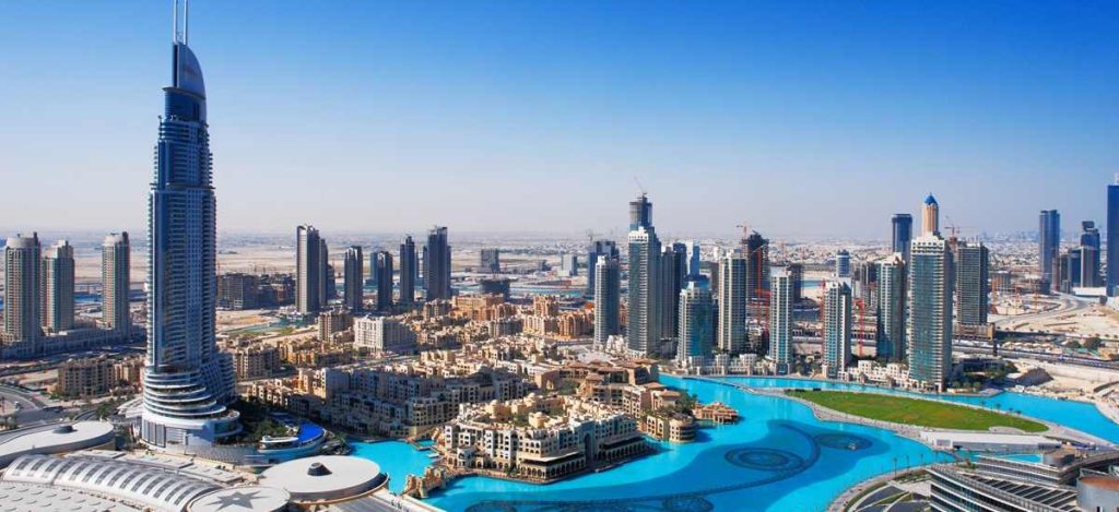 Dubai skyline with skyscrapers and blue water.