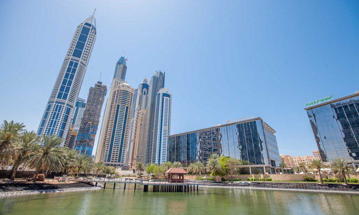 Modern skyscrapers by a waterfront in Dubai.