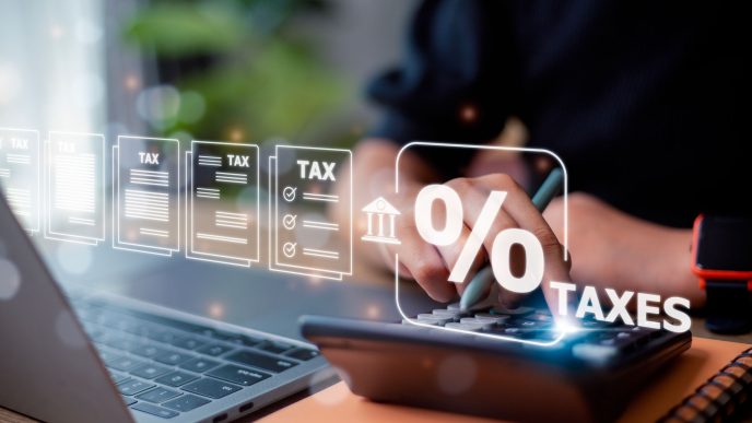 Person calculating taxes on a calculator