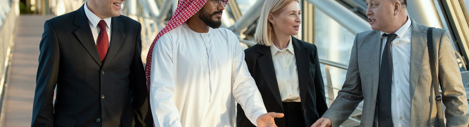 Diverse business group walking in modern corridor in Dubai