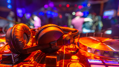 DJ headphones on a mixing console in nightclub