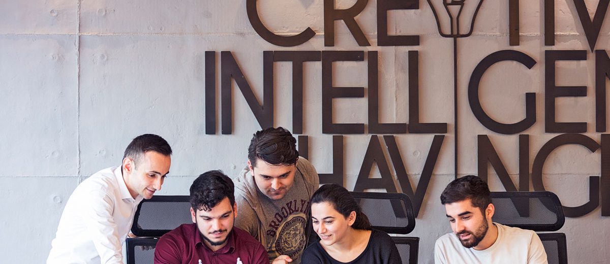 UK startups - Team collaborating in modern office workspace.