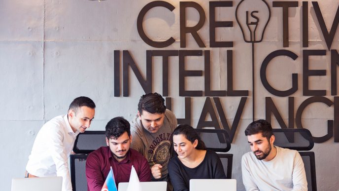 UK startups - Team collaborating in modern office workspace.